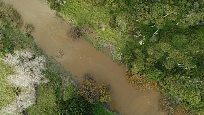 Overhead shot of a flooded river with surrounding vegetation