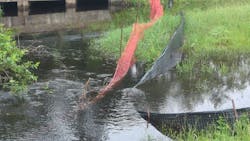 Damaged, submerged silt fencing, orange wetland marker netting to note area not to be disturbed during construction. Damaged, submerged silt fencing, orange wetland marker netting to note area not to be disturbed during construction.