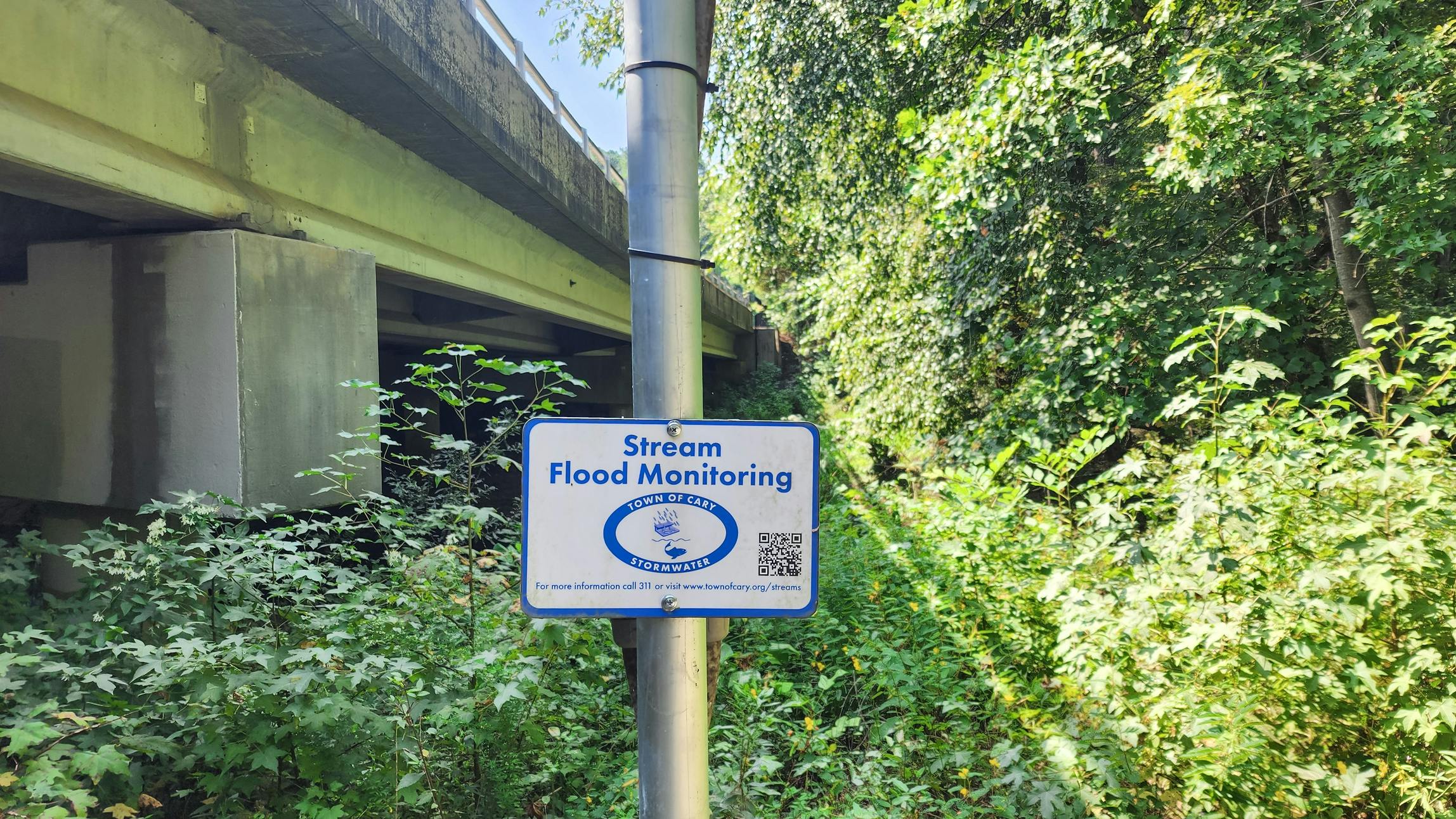 Stormwater management sign under bridge in North Carolina town
