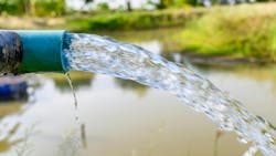 Agriculture blue pipe with groundwater gushing in pond Agriculture blue pipe with groundwater gushing in pond