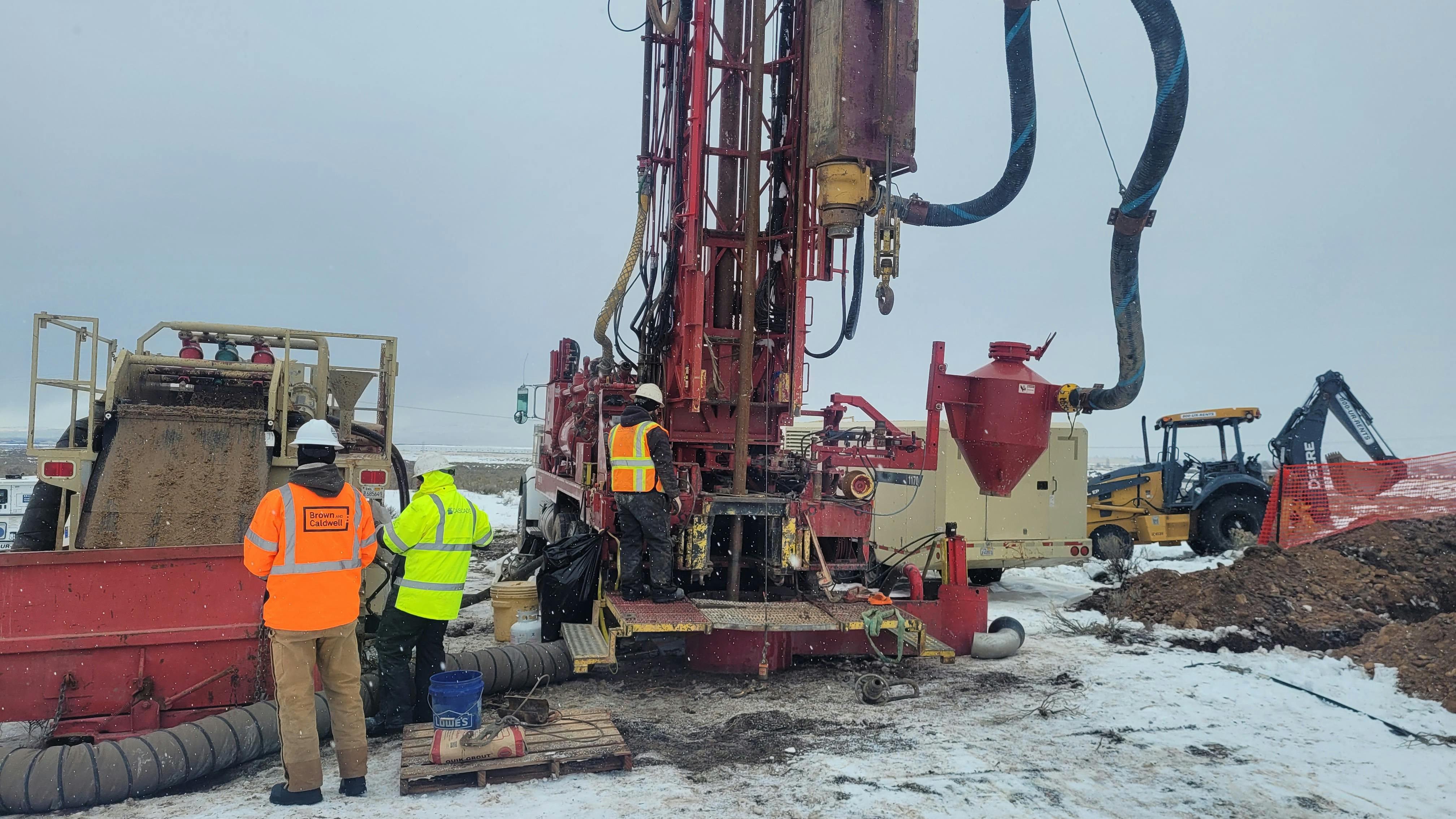 Monitoring well drilling operations for groundwater well installation and geochemical sample collection.