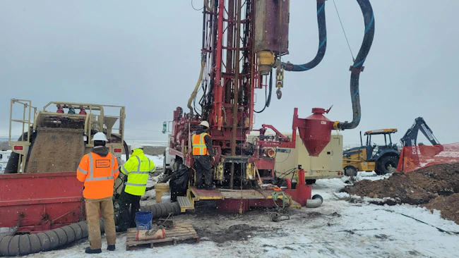 Monitoring well drilling operations for groundwater well installation and geochemical sample collection.