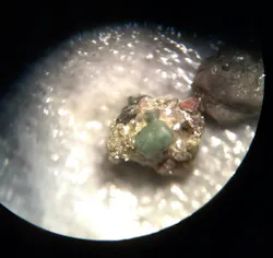 Microphotograph of aquifer samples showing sand grains surrounded by a pyrite mineral matrix. Microphotograph of aquifer samples showing sand grains surrounded by a pyrite mineral matrix.