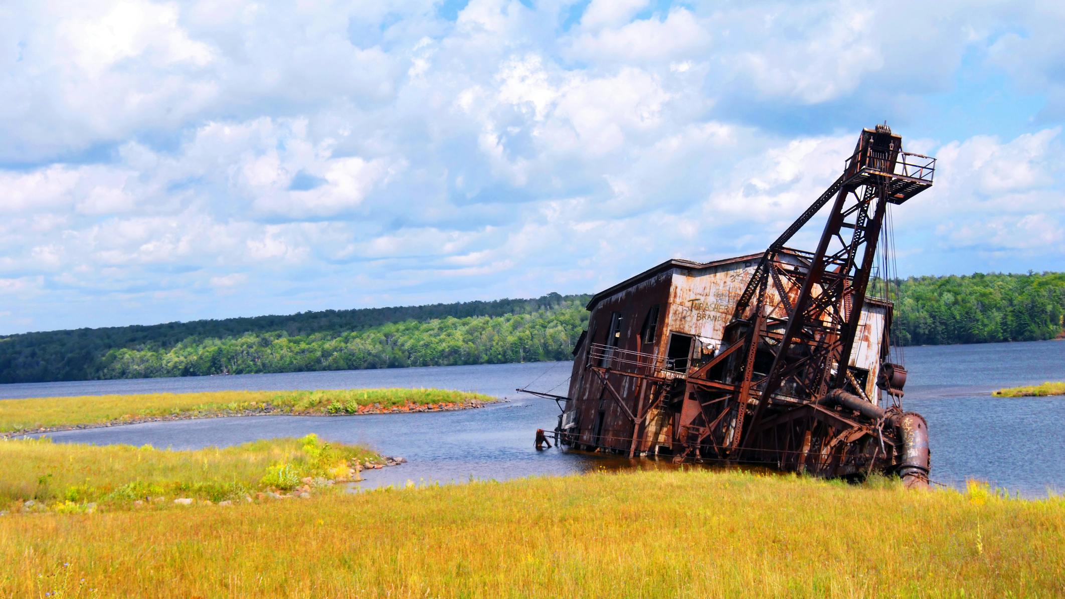 Abandoned copper reclamation suction dredge, sits in the waters of Torch Lake in Upper Peninsula, Michigan