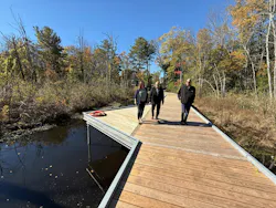 Sustainability efforts involved the use of black locust decking to eliminate the need for chemical treatment, reuse of clean soils to divert it from landfills, and the repurposing of removed trees as mulch, all to reduce waste, lower costs, and reinforce environmental goals.